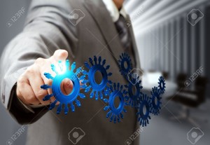 16080939-business-man-hand-point-cogs-icons-in-board-room-Stock-Photo-business-support-technology